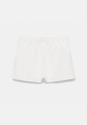 Hvide elastiske taljeshorts med sidelommer, lavet af blødt stof, vist på en lys baggrund.