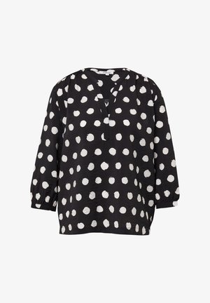 Blouse noire à pois blancs, avec un décolleté en V, des manches trois-quarts et des détails froncés aux épaules et aux poignets.