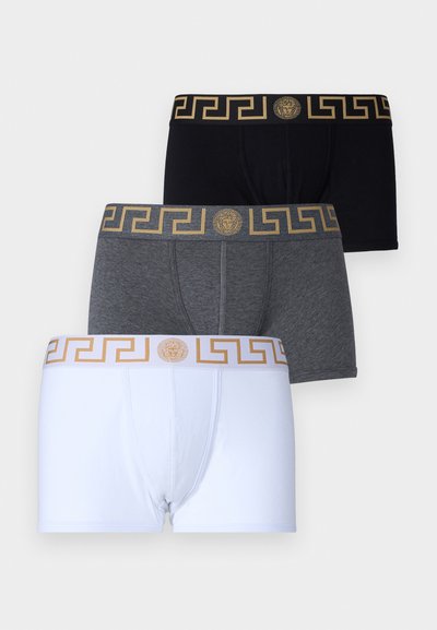 Three pairs of boxer briefs in black, gray, and white. Each has a gold-patterned waistband featuring a Greek key design and a logo.