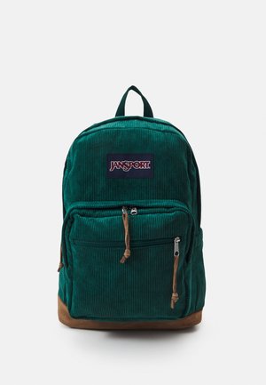 Green corduroy backpack with a tan bottom, front zip pocket, and logo patch. Features adjustable straps and a top handle.