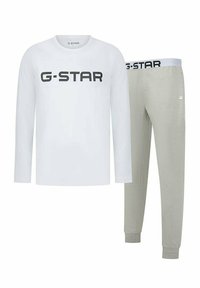 Witte langek mouwen shirt met zwart "G-STAR" logo, gecombineerd met lichtgrijze sweatpants met een bijpassende tailleband en taillebanden.