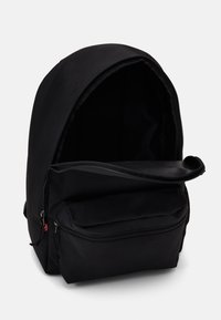 Black fabric backpack featuring a rounded top, a large main compartment with a zipper, and a front zipped pocket for added storage.