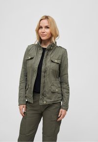 Olive green military-style jacket with a zip front, four pockets, button accents, and a high collar; cotton blend fabric; relaxed fit.
