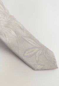 Light gray tie with a textured fabric featuring a subtle floral pattern in slightly darker gray tones. Tapered end with a smooth finish.