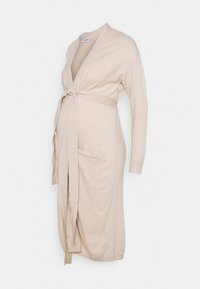 Beige lange cardigan met lange mouwen, striksluiting in de taille en twee voorkleding. Gemaakt van zachte, gestructureerde brei stof.