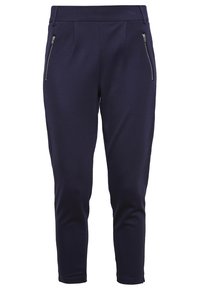Navy tailored pants made of a smooth fabric, featuring side zip pockets, pleats at the waist, and a fitted ankle-length design.
