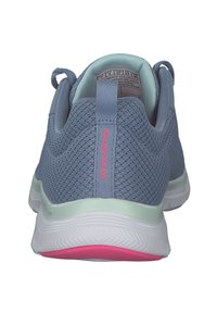Scarpa sportiva azzurro chiaro con tomaia in mesh, pannelli testurizzati e un accento rosa sulla suola. Caratterizzata da un tab di estrazione sul tallone.