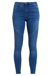 Modré džíny skinny z denimu s žebrovanými detaily na kolenou, klasický design s pěti kapsami a zipovým zapínáním na knoflík.