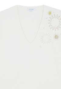 White V-neck t-shirt featuring gold embroidered starbursts and bead accents on one side. Smooth, soft fabric with a casual design.