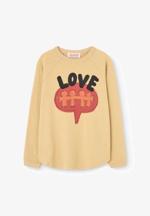 Beige long-sleeve shirt with a red speech bubble containing four linked stick figures and the word "LOVE" in bold black letters above.
