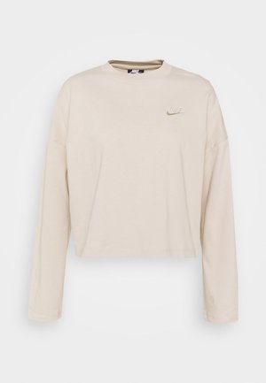 Beige langærmet Nike cropped sweatshirt med rund hals og lille, broderet logo på venstre bryst.