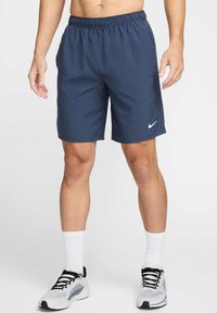 Bermudas deportivas de color azul marino con cintura elástica, textura suave y un logo blanco de Nike en el dobladillo inferior izquierdo.