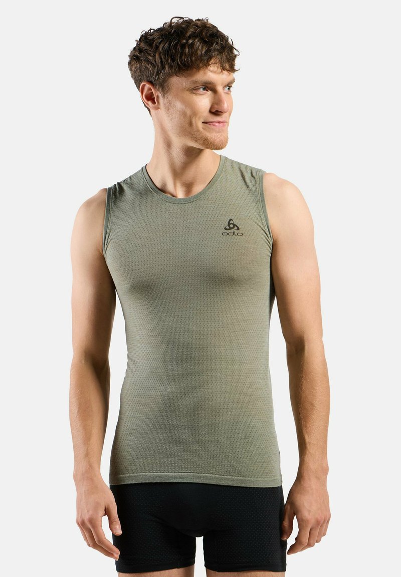 Light green sleeveless athletic top, textured fabric, round neckline, featuring a small black logo on the left chest area.