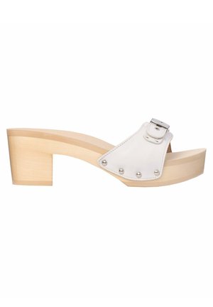 Białe platformowe klapki z szerokim paskiem i srebrną klamrą, drewnianym obcasem oraz metalicznymi ćwiekami wzdłuż krawędzi dla podkreślenia detali.