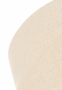 Zacht beige gebreide stof, met een gladde textuur en subtiele rek, met diagonale patronen die een cilindrische vorm creëren.