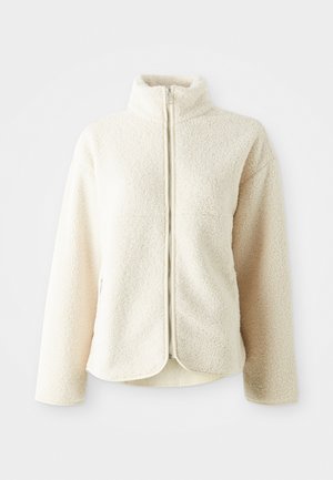 Soft, cream-colored fleece jacket with a high collar, full zipper, and a relaxed fit. Features a textured, fluffy exterior.