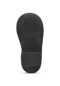 Suela de zapato de goma negra con estrías texturizadas, marcada con el número 19, que presenta un parche liso y bordes redondeados.