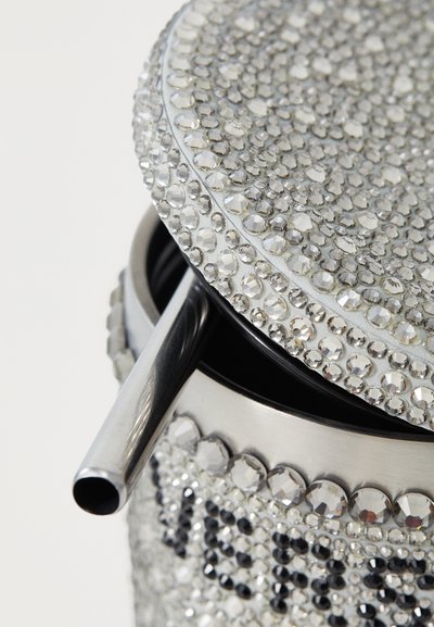Silver metallic container with a lid adorned in clear rhinestones, featuring a metal straw and circular shape. Smooth and reflective surface.