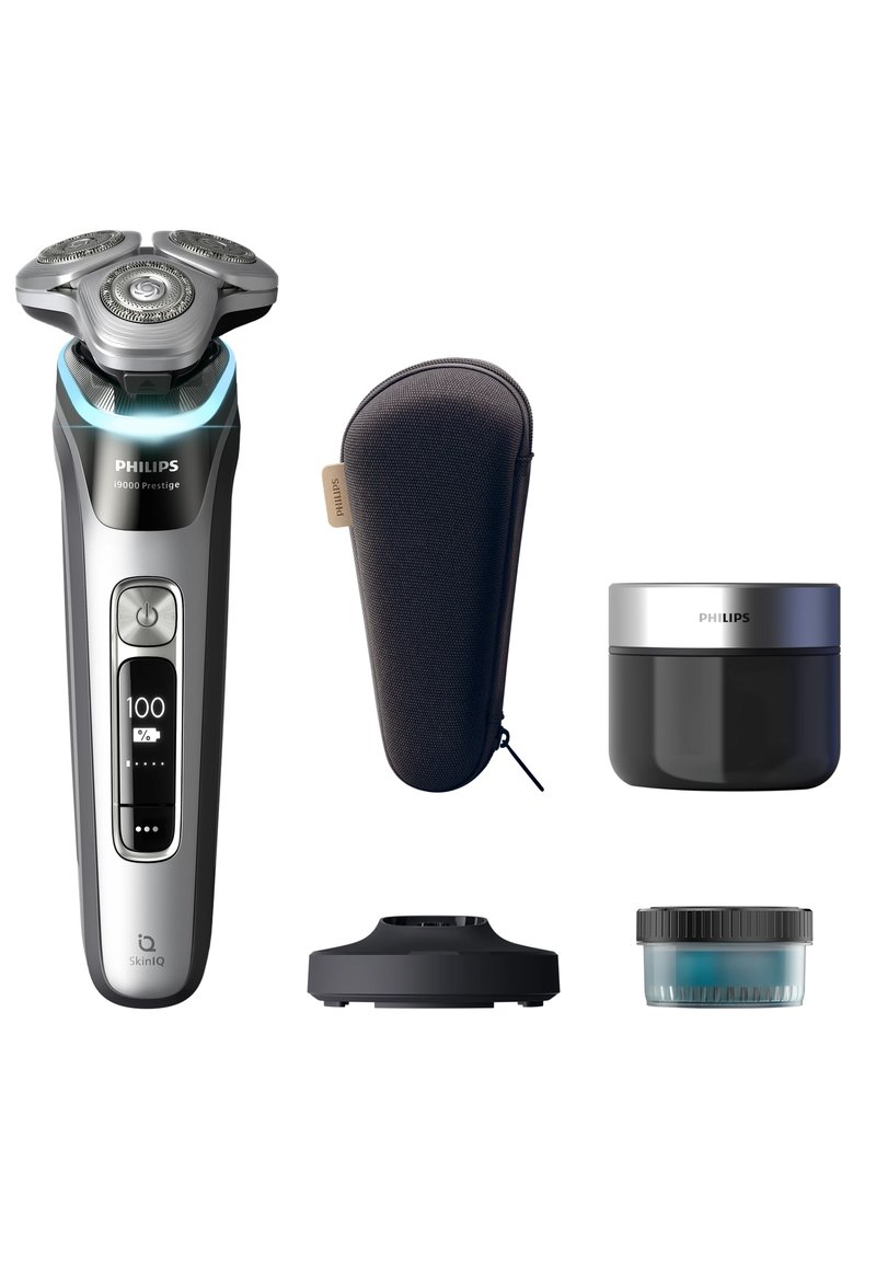 Philips Series 9000 elektrische scheerapparaat in zilver en zwart, met een ontwerp met drie koppen, een oplaadstation, een reiskoffer en verzorgingscrème.