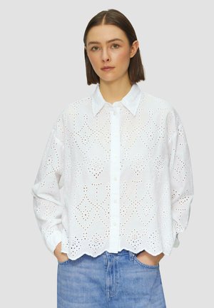 White cotton shirt with broderie anglaise detail, button-up front, and scalloped hem. Relaxed fit with long sleeves and a classic collar.
