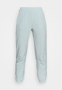 Light mint-green joggers made of smooth fabric. Features an elastic waistband, tapered cut, and subtle side pockets. Simple design.