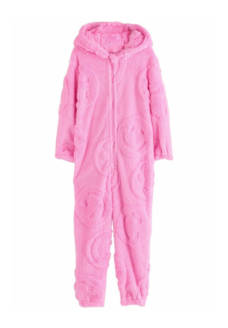 Combinaison en polaire rose avec une fermeture éclair à l'avant, une capuche et des textures de visage souriant circulaires sur tout le tissu. Design doux et confortable pour un usage décontracté.