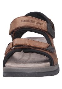 Brown leather sandal with two adjustable straps, black accents, and a cushioned suede footbed. Textured rubber sole for grip.