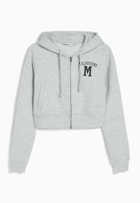 Felpa corta grigia con zip, realizzata in tessuto morbido. Presenta un cappuccio, tasche frontali e la scritta "MELBOURNE" con un logo "M" sul lato sinistro del petto.