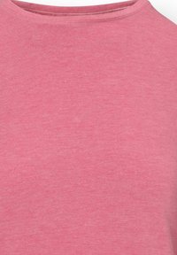 Soft pink crew neck fabric with a smooth knit texture and subtle heathered pattern, showing the upper chest and neckline area.