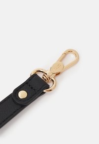 Fekete bőrszíj arany fém csattal és szerelvényekkel, sima felülettel, a csaton pedig látható márkajelzés található.