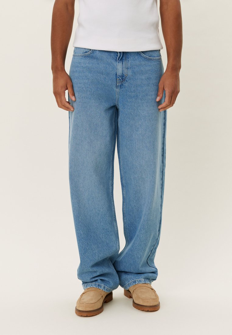 Light blue wide-leg jeans made from denim, featuring a classic five-pocket design, with a relaxed fit and a frayed hem for added texture.