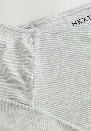 Light gray ribbed fabric top featuring a round neckline and a seam detail on the side; soft texture with subtle vertical stripes.