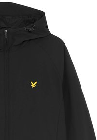 Veste noire zippée avec capuche, ornée d'un logo d'aigle jaune sur la poitrine et de cordons réglables. Tissu lisse avec un design épuré.
