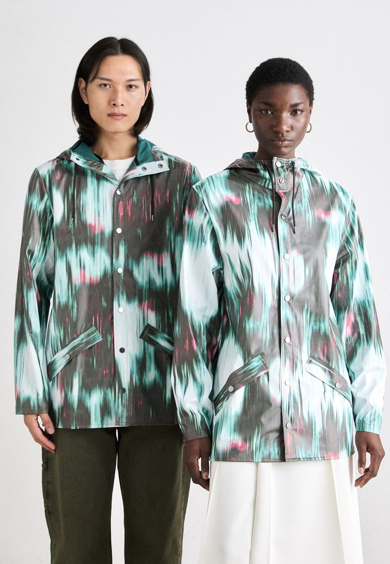 Two waterproof jackets with a vibrant green, blue, and pink pattern; features a hood, snap buttons, and front pockets; smooth texture.
