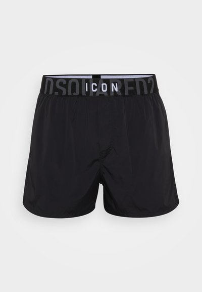 Sorte svømmebukser med elastisk talje og et kontrasterende logo. Fremstillet af letvægtsmateriale, designet til komfort og bevægelsesfrihed.