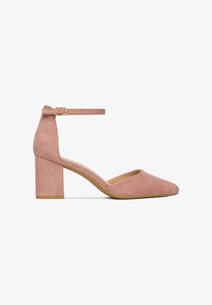 Mauvefarbener Wildleder-Damenschuh mit Blockabsatz, spitz zulaufender Zehenpartie und Knöchelriemen mit kleiner goldener Schnalle vor weißem Hintergrund.