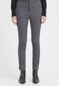 Enganliegende Leggings mit einem dunkelblauen und goldenen Hahnentrittmuster, aus glattem Stoff, mit mittlerer Bundhöhe und knöchellanger Länge.