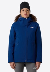 Blue waterproof jacket with a hood, front zipper, two side pockets, elastic cuffs, and adjustable drawstrings. Brand logo on the chest.