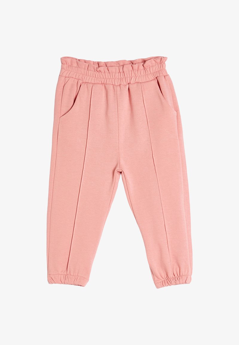 Vaaleanpunaiset joustavat housut, joissa on röyhelövyötärö, kaksi sivutaskua ja etuosassa ommellut laskokset. Housujen lahkeet ovat elastiset.