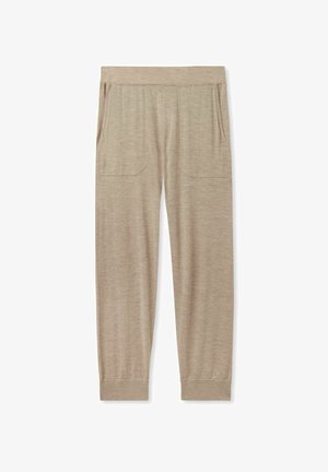 Beige Jogginghosen aus weichem Stoff, ausgestattet mit einem elastischen Bund, zwei Seitentaschen und schmal zulaufenden Bündchen an den Knöcheln.