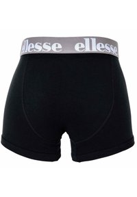 Boxer in cotone nero con una cintura elastica grigia decorata con il branding bianco "ellesse" e dettagli cuciti. Texture liscia e design aderente.