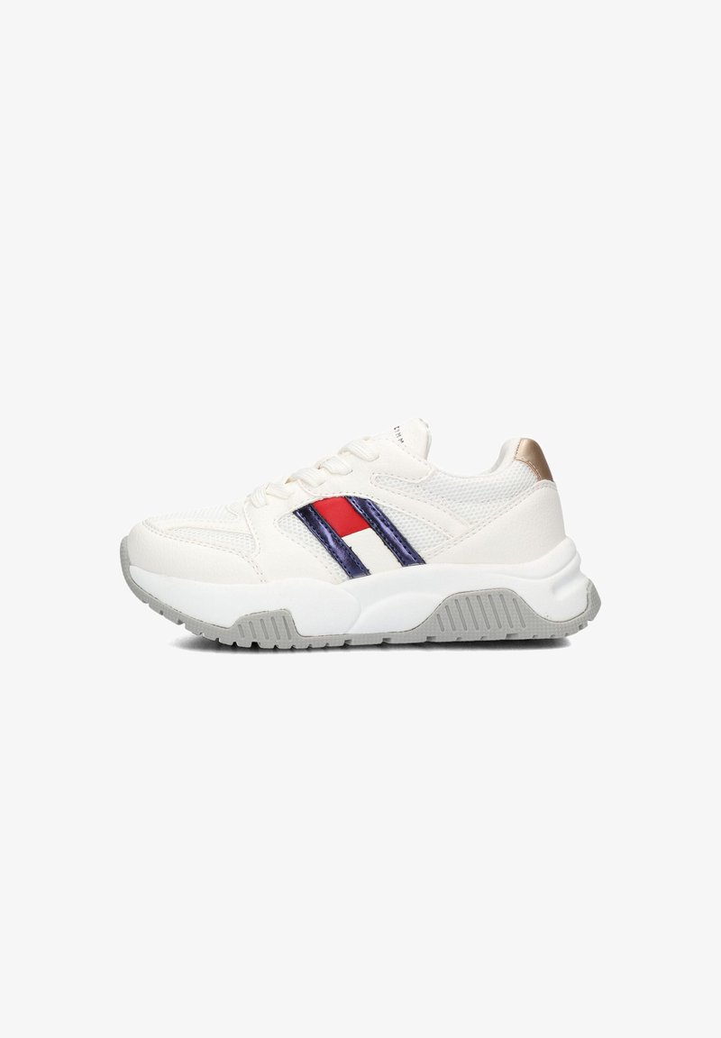 White sneaker with mesh and synthetic materials, featuring red, blue, and white stripes. Grey sole with textured detailing, gold accent on heel.