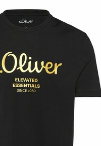 Black cotton t-shirt featuring a crew neck, gold printed text: “s.Oliver ELEVATED ESSENTIALS SINCE 1969” on the front.