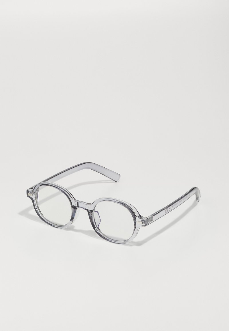 Transparent, round glasses with clear lenses; thick frame with a smooth texture; straight temples; minimalistic design.