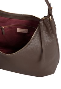 Borsa in pelle color taupe con zip dorata. Presenta un esterno liscio e un interno in tessuto bordeaux, comprensivo di una piccola tasca con zip.