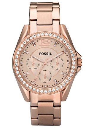 Zegarek na rękę Fossil w kolorze różowego złota z ozdobionym kryształami bezelem, trzema subtarczami i metalową bransoletą, wyświetlający czas i datę.
