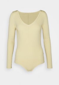 Pitkähihaisen bodysuitin pehmeä keltainen ribbikangas, jossa on V-kaula-aukko ja tiukka siluetti neuletekstiilillä ja saumattomalla alaosalla.