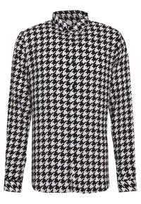 Långärmad skjorta i svartvitt hundtandsmönster, med knappar framtill och klassisk krage. Slät tyg, normal passform.