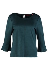 Top verde a maniche lunghe in un materiale morbido con scollatura rotonda e apertura a chiave sul retro. Presenta orli delle maniche svasati e una superficie liscia.