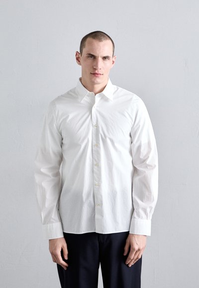 White long-sleeve button-up shirt with a classic collar, featuring a crisp texture and subtle sheen, paired with dark trousers.